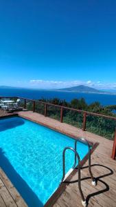 a swimming pool with a view of the ocean at Giardino 21 Marzo in Vico Equense