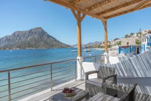 a balcony with chairs and a view of the ocean at Next to the wave in Myrties