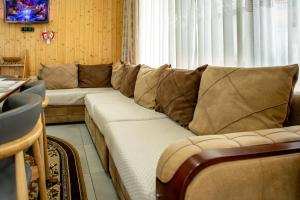 a living room with a couch and a window at VILLA EVA - 5 min to the beach in Shekhvetili