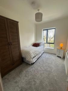 a bedroom with a bed and a window at House Sleeps 6 with Parking in Coad