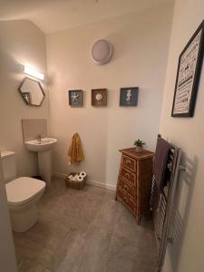 a bathroom with a toilet and a sink at House Sleeps 6 with Parking in Coad +13 photos