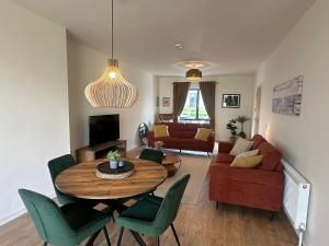 a living room with a table and chairs at House Sleeps 6 with Parking in Coad