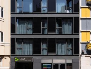a tall black building with lots of windows at LSA Parque by Numa in Lisbon +44 photos