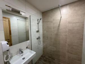 a bathroom with a shower and a sink at Bakuriani Valley 09 in Bakuriani +34 photos