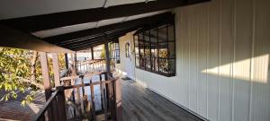 a porch of a house with a door and windows at Paralelo46 in Chile Chico