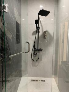 a shower with a glass door in a bathroom at Shahzam Hotel in Samarkand +18 photos
