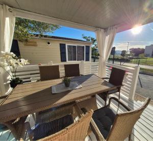 a wooden table and chairs on a deck at Mobile home San Antonio in Sveti Filip i Jakov +26 photos