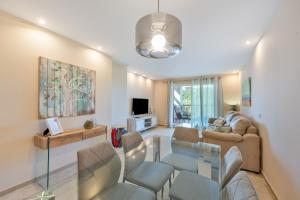 a living room with a glass table and chairs at Alcaidesa Golf in La Alcaidesa