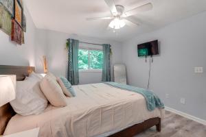 a bedroom with a bed with a ceiling fan at 7 Mi to Downtown Fun! Spacious Augusta Condo in Augusta