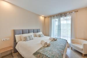 a bedroom with a large bed with towels on it at Alcaidesa Golf in La Alcaidesa +30 photos