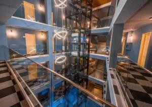 a glass staircase in a building with a lobby at Bakuriani Valley 09 in Bakuriani