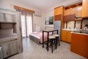 a small kitchen with a table in a room at Azura Studios in Stavros