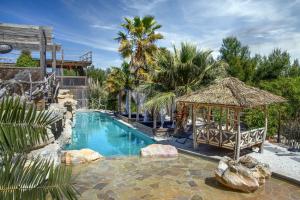 a swimming pool with a gazebo and a resort at Villa Occitana in Calvisson