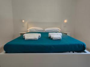 a large blue bed with towels on top of it at Casa Bolina in Senigallia