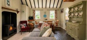 a living room with a couch and a fireplace at Wild Rowan Cottage - 2 Bedroom in Louisburgh