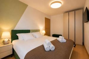 a bedroom with a bed with towels on it at Visum Residence Labin - Luxury sea view retreat in Labin