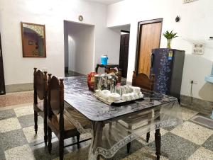 a dining room table with a tray of food on it at Anjali Homestay - 10 mins from Bagdogra airport in Siliguri