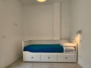 a small bedroom with a bed with a blue blanket at Casa Bolina in Senigallia