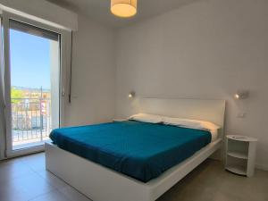 a bedroom with a bed and a large window at Casa Bolina in Senigallia