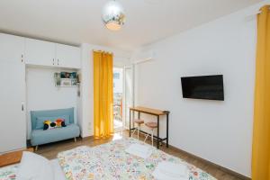 a bedroom with a bed and a table and a tv at Narancin Apartments in Trogir