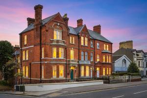 a large brick building with its lights on at Clarence House in Derry Londonderry