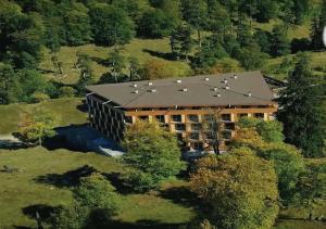 an aerial view of a large building in the woods at Bakuriani Valley 09 in Bakuriani