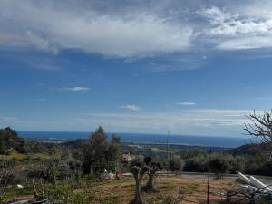 a view of the ocean from a hill at Old Luxury Stone House Armou in Armu