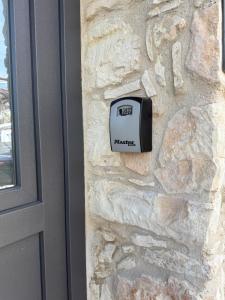 a door sensor on the side of a stone wall at Old Luxury Stone House Armou in Armu