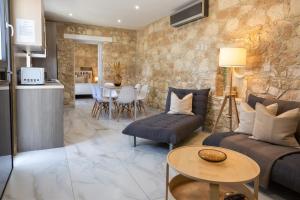 a living room with a couch and a table at Old Luxury Stone House Armou in Armu