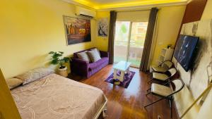 a bedroom with a bed and a couch at Relaxing Studio-Malibu El Sokhna Resort in Ain Sokhna