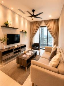 a living room with a couch and a tv at Suasana Johor Bahru City Centre by SummerSpace in Johor Bahru