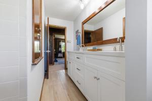 a kitchen with white cabinets and a mirror at Hiwassee Lake Lodge - Private Mtn-Top Retreat - Lake Views - Sleeps 14 in Murphy