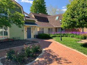 a house with a brick driveway in front of it at Strawtown Inn & Events in Pella