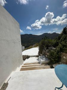 a stairway leading up to a building with mountains in the background at Serenity Nest Serifos in Serifos Chora