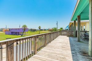 a wooden boardwalk leading to a park with houses at Steps from the Jetty & Beach in Surfside Beach +31 photos