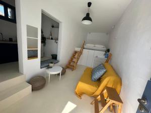 a small room with a couch and a bed in it at Serenity Nest Serifos in Serifos Chora