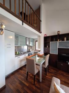 a kitchen with a table and chairs in a room at VeronaVera Porta Palio Panoramic Loft in Verona