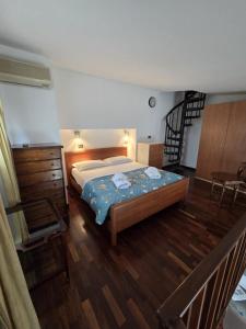 a bedroom with a bed and a wooden floor at VeronaVera Porta Palio Panoramic Loft in Verona