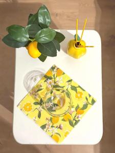 a white tray with a glass of juice and a plant at Lemon House in Stezzano