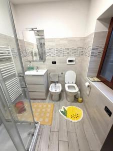 a bathroom with a toilet and a sink and a shower at Lemon House in Stezzano +21 photos