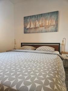 a bedroom with a large bed with two pillows at Apartment Rita in Mokošica