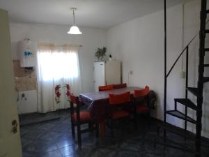 a kitchen with a table and chairs and a refrigerator at Duplex Hermosinda Hospedaje in Chilecito +9 photos