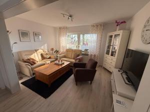 a living room with a couch and a table at Vakantiewoning MaRa in Neuenhaus