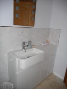 a bathroom with a white sink and a mirror at Dripshill Lodge in Severn Stoke +19 photos