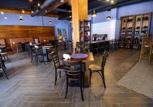 a restaurant with tables and chairs in a room at Bakuriani Valley 09 in Bakuriani