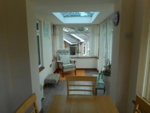 a living room with a skylight in the ceiling at Dripshill Lodge in Severn Stoke