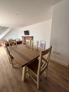 a dining room with a wooden table and chairs at Chapel Fields Holiday Park in Chapel Saint Leonards