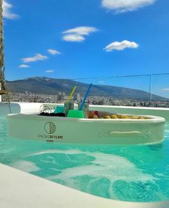 a boat floating in the water in a swimming pool at One 360 Skyline Athens Penthouses in Athens