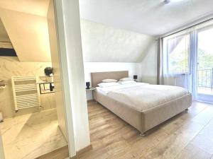 a bedroom with a bed and a large window at Oana's Boutique in Bran