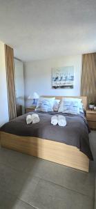 a bedroom with a large bed with three towels on it at Villa Ružmarin in Lovište